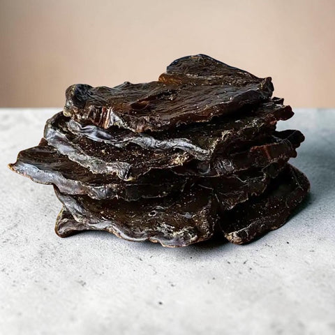 a stack of dried livery treats for dogs on a kitchen counter