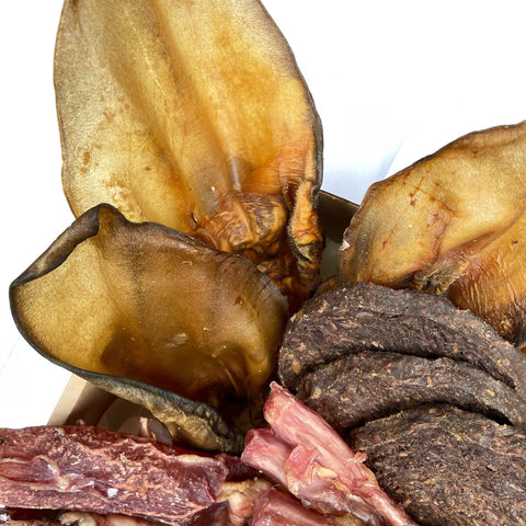 Six air-dried beef ears with meat, high-protein chews included in the Big Beef Chewer box.