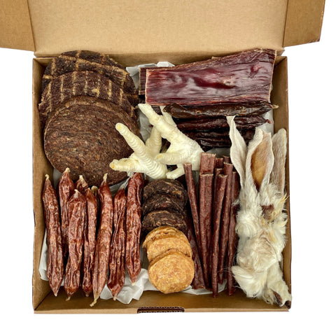 Aerial view of the Butcher’s Banquet box filled with natural dog treats from Betty & Butch.