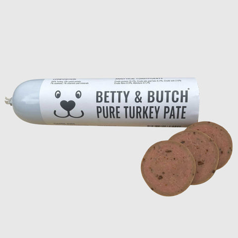 Tube of Betty & Butch Pure Turkey Pate with three slices on a white background