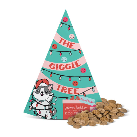 Christmas tree-shaped packaging for 'The Giggle Tree' with dog treats on a white background