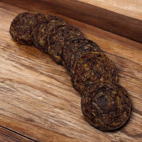 six premium beef burger treats for dogs on a wooden bench