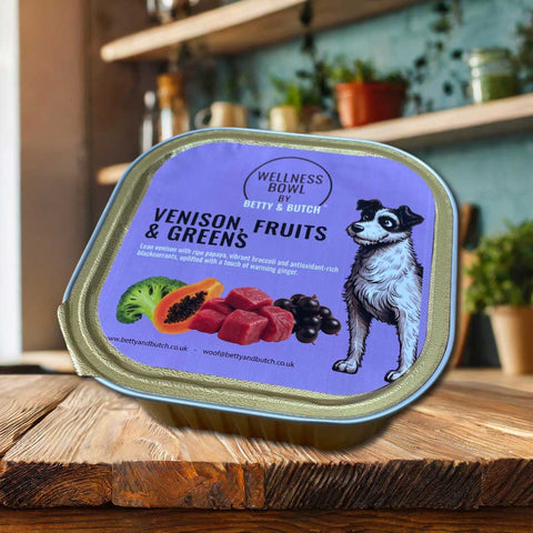 Wellness Bowl by Betty & Butch pet food container with purple label featuring a dog illustration on a wooden surface.