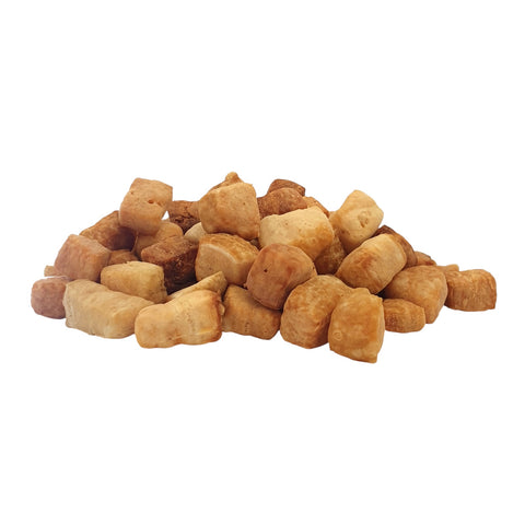 pile of yak soft treats for dogs on a white background
